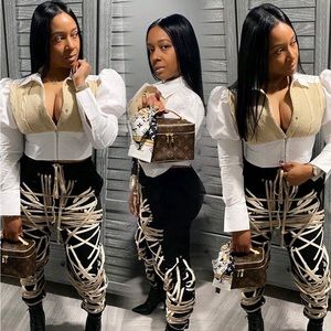 30% Cotton. 70% Polyester. Buttons up top. Corset hooks on bottom.